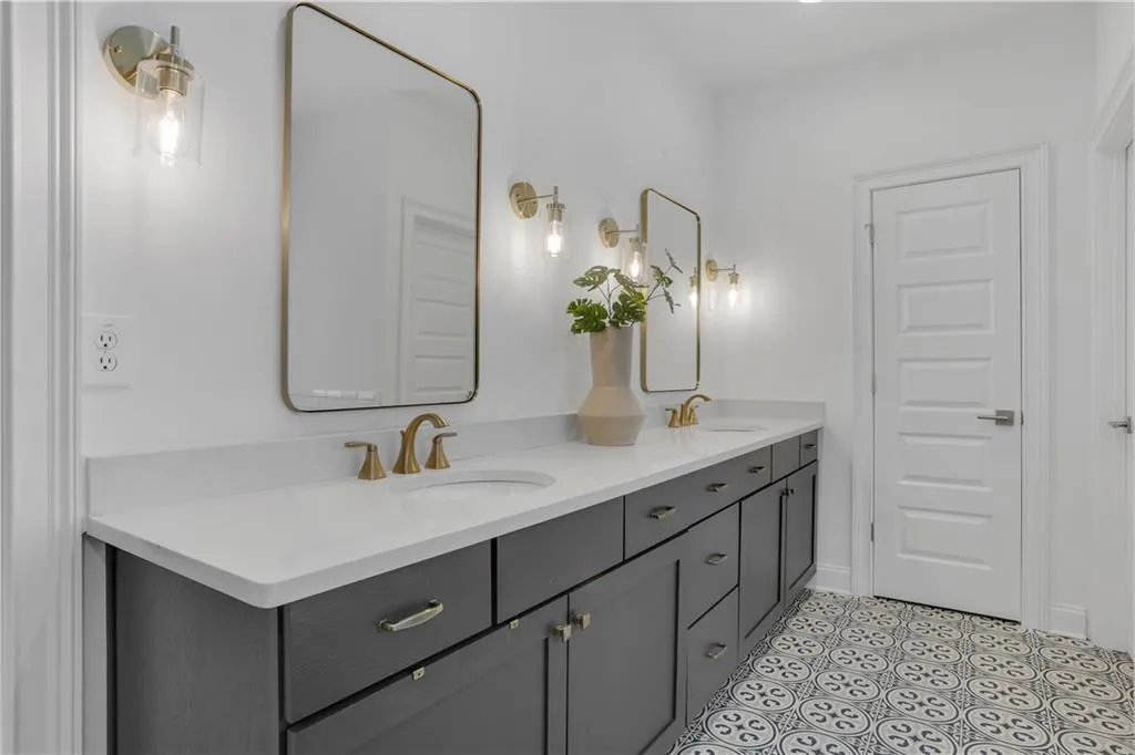 Dual vanity with a white countertop and dark cabinetry