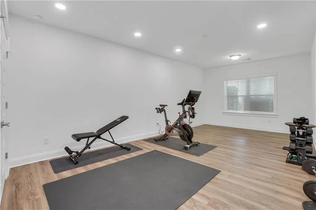Spacious room featuring light wood-finish flooring and ample natural light from a large window