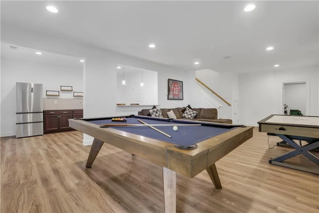 Recreation room featuring wood-finish flooring and recessed lighting