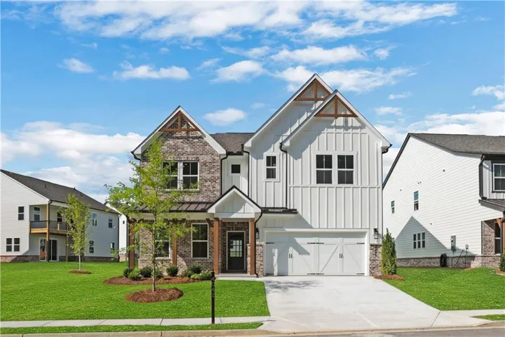 Modern farmhouse exterior featuring brick and vertical siding