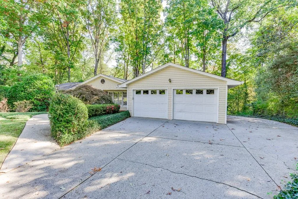 Garage featuring concrete driveway