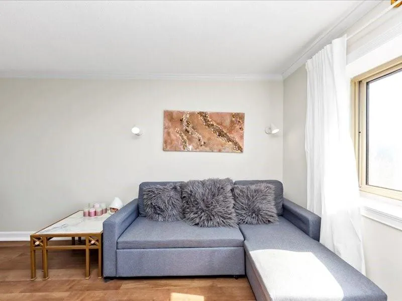 Living area featuring ornamental molding and wood finished floors