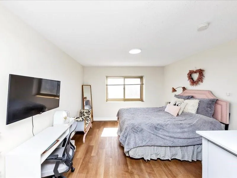 Bedroom featuring light wood finished floors and baseboards