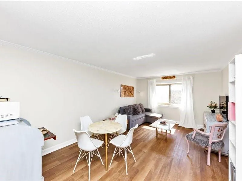 Dining room featuring light wood-style flooring and crown molding
