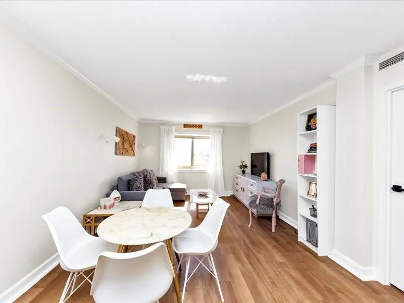 Dining area with light wood-style floors and ornamental molding