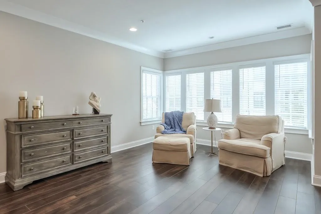 Primary Bedroom with sitting and an abundance amount of light