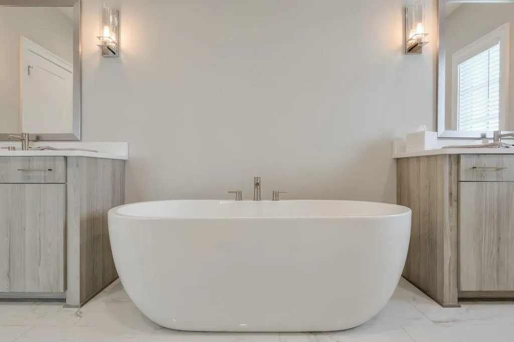 Primary bathroom with marble flooring and soaking tub