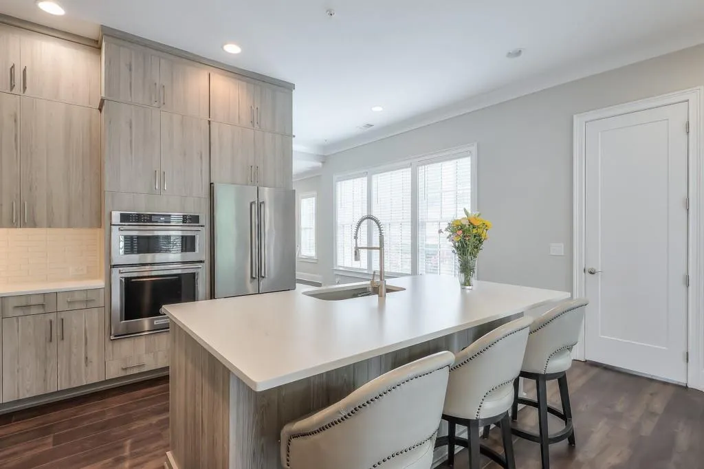 Kitchen Island with sink, Stainless Steel appliances and an abundance of natural light

flooring