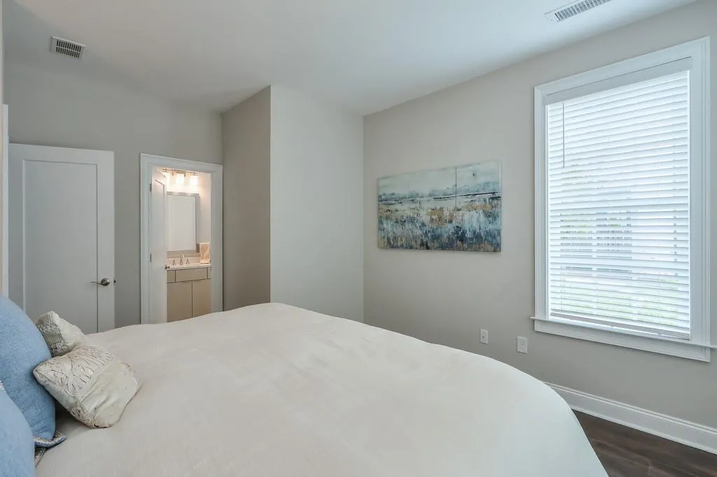 Terrace Bedroom featuring multiple windows with natural light, hardwood floors and ensuite bathroom