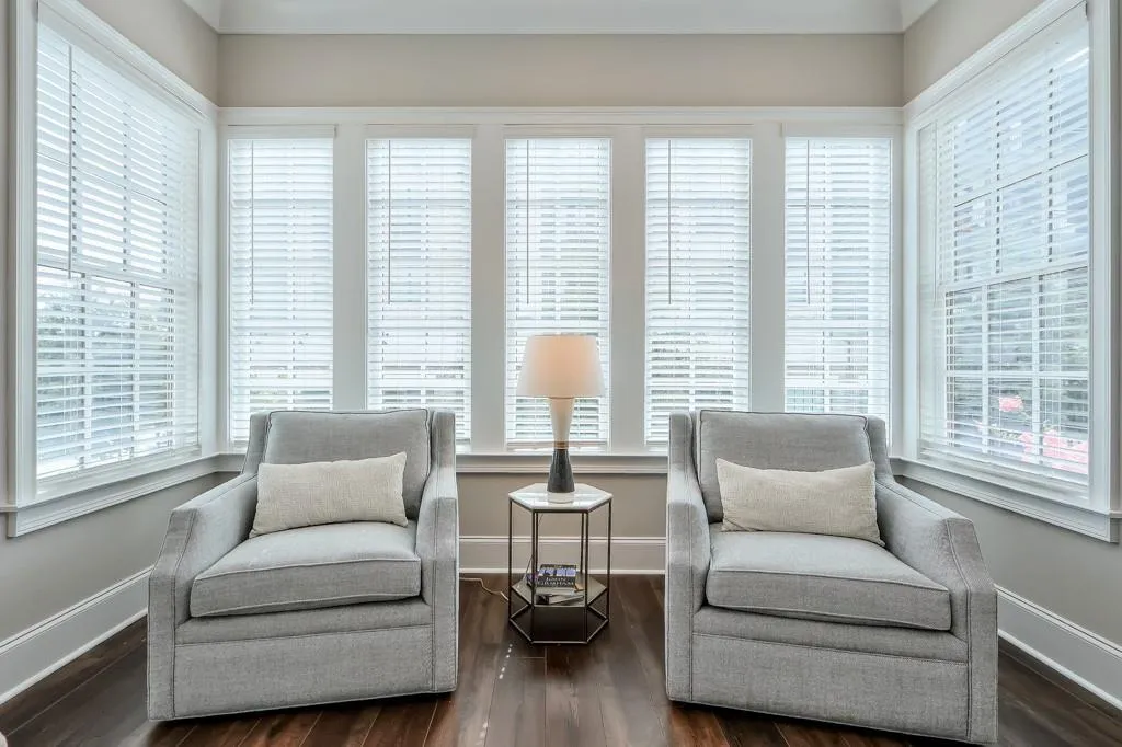 Main Level sitting area with an abundance of natural light and hardwood floors