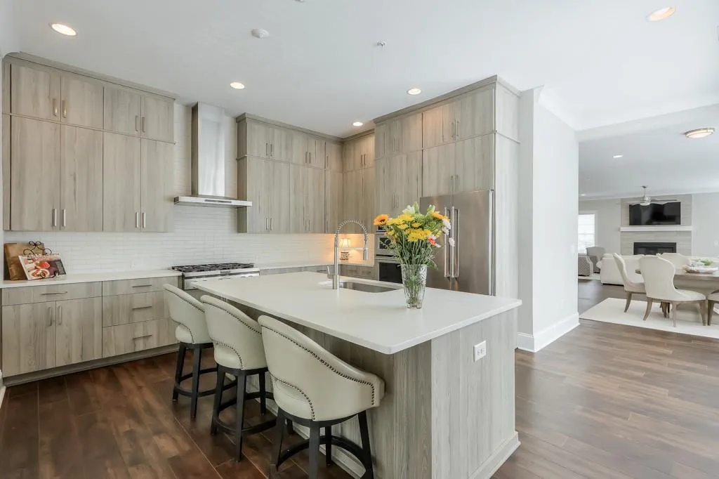 Kitchen with Stainless Steel Appliances, hardwood flooring, kitchen island and a Stainless Steel exhaust hood
