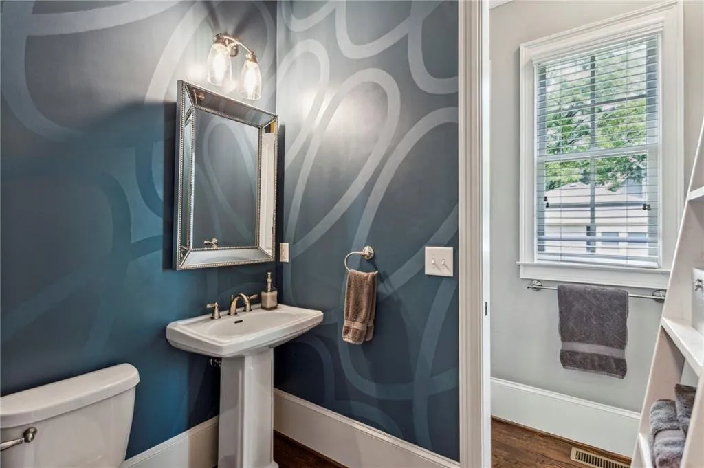 Bathroom on the main floor with shower serves as both full bath for guest room and powder room