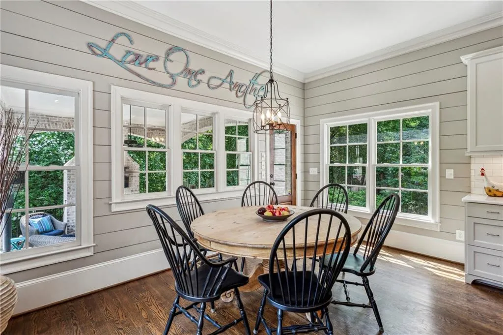 Breakfast area with lots of natural light, opens to covered brick patio and pool