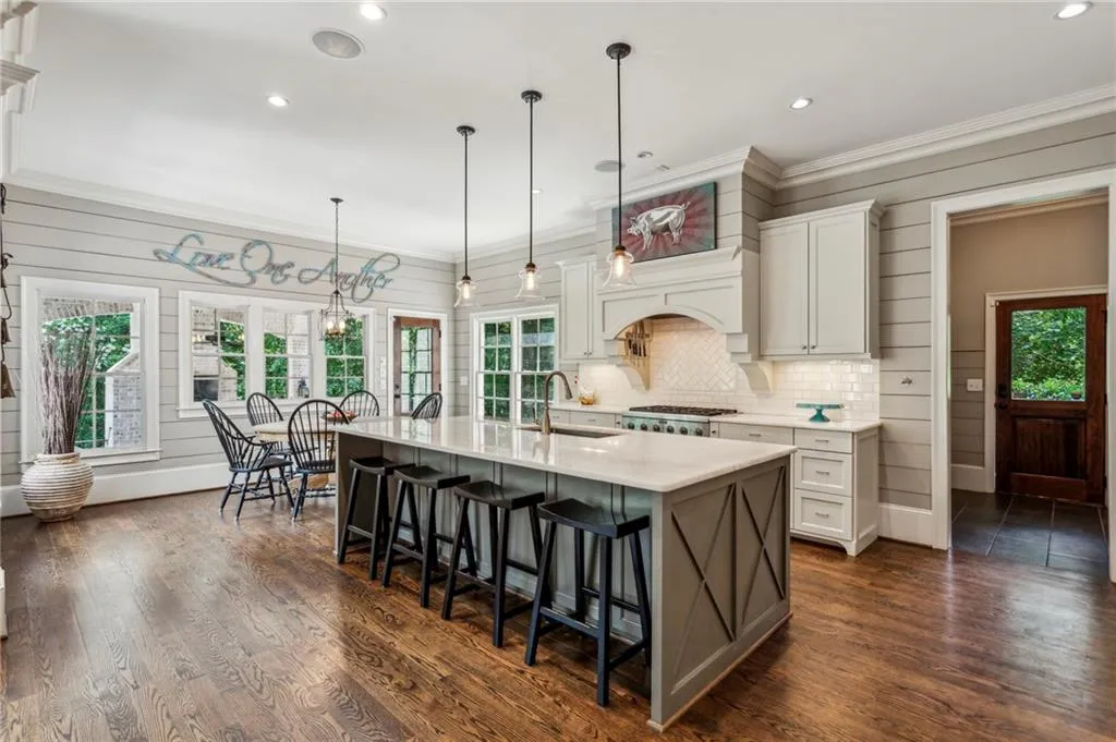 Kitchen featuring marble countertops, a kitchen breakfast bar, plenty of natural light, and recessed lighting
