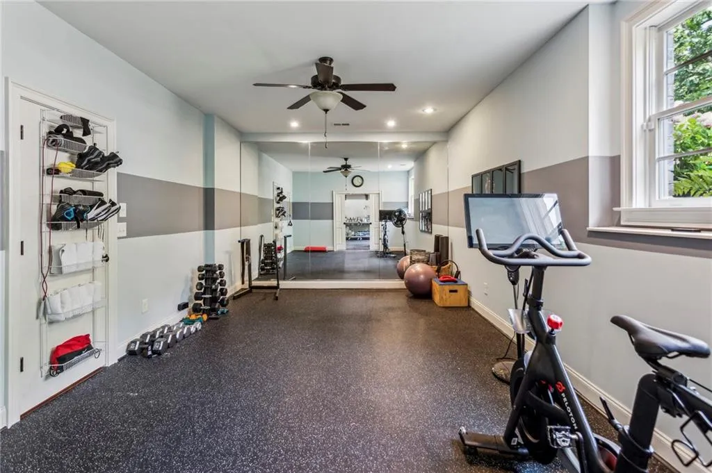 Exercise room on the terrace level featuring ceiling fan, baseboards, and recessed lighting
