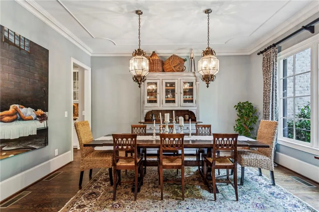 Dining space featuring a chandelier, plenty of natural light, crown molding, and baseboards