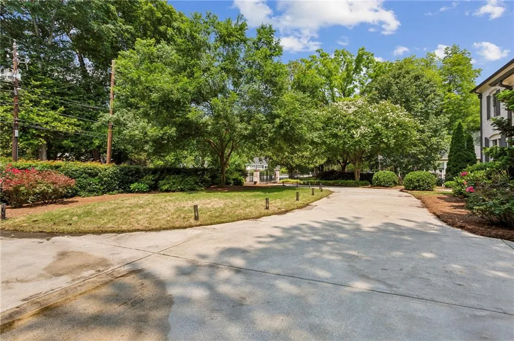 Front yard is private and fenced, both ends of the curved driveway are gated