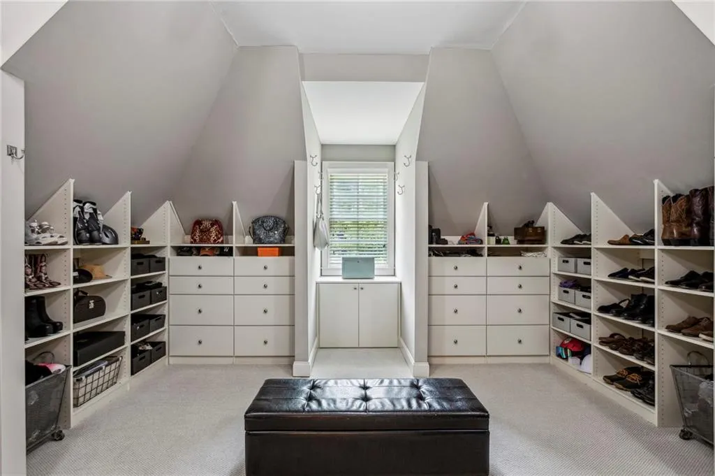 Walk in closet featuring vaulted ceiling and built-ins