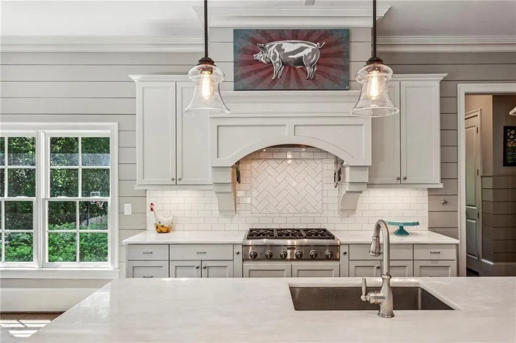 Kitchen featuring stainless steel Thermador gas stovetop and vent hood
