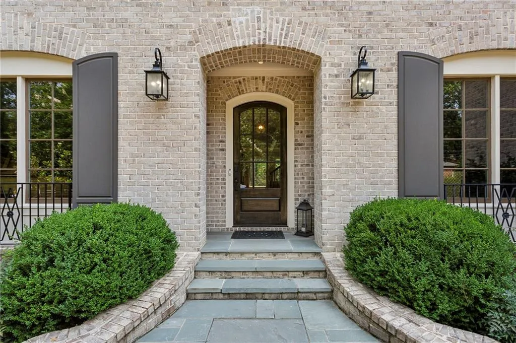 Doorway to property featuring brick siding