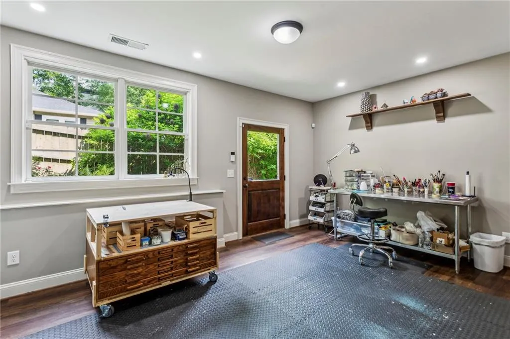 Terrace level room currently serves as an artist's studio. Lots of natural light, door to backyard