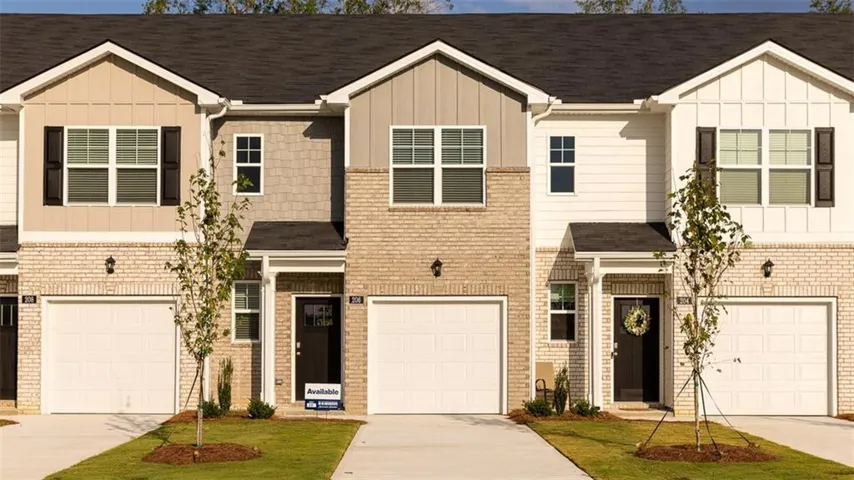 Contemporary facade with mixed material siding, light brick accents, and dark shutters
