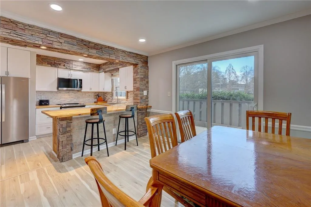 Dining space featuring light wood finished floors, recessed lighting, and crown molding