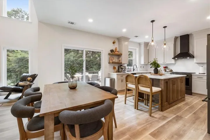 Open-concept living area featuring wood-finish flooring and abundant natural light