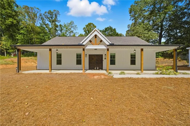 Contemporary farmhouse exterior featuring white board and batten siding