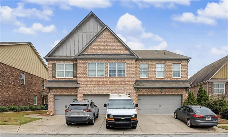 Brick exterior with a prominent front gable featuring vertical siding