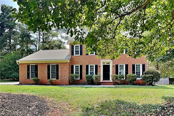 Brick exterior with black shutters