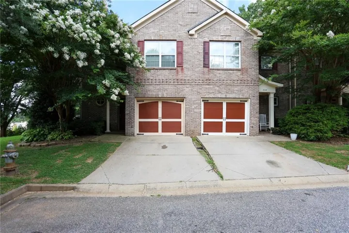 Brick facade with white window trim and red shutters