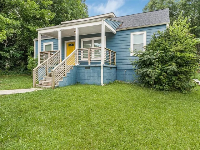 Blue siding exterior with a contrasting yellow front door