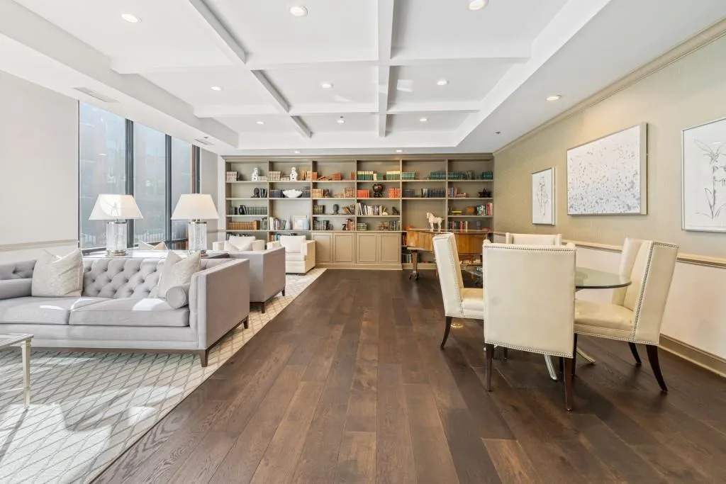 Gathering area off lobby complete with sofas, chairs, piano, and library