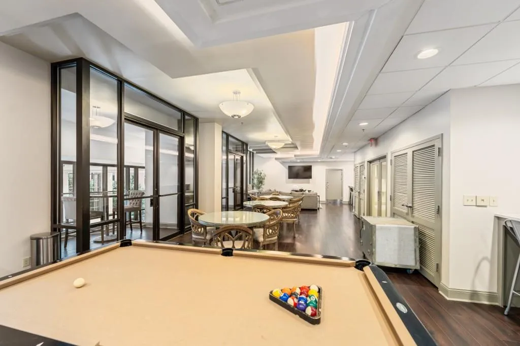 Fifth floor recreation room with pool table, table/chairs, kitchen, two flat screen TV's