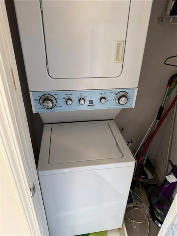 Laundry area with stacked washer and dryer