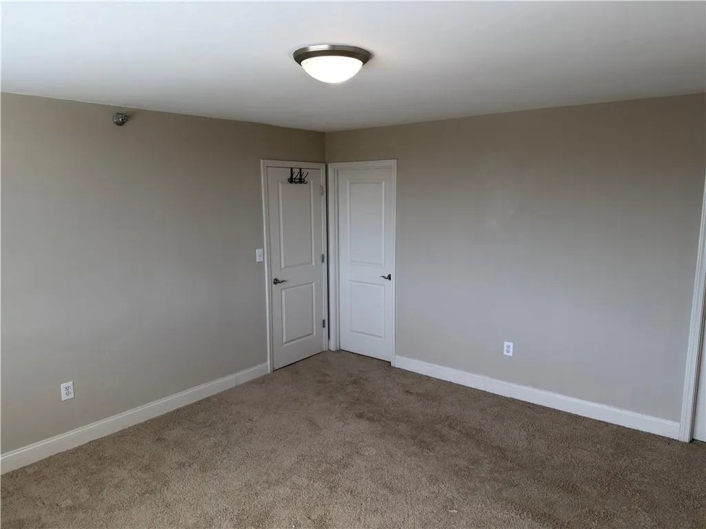 Unfurnished room with baseboards and carpet floors
