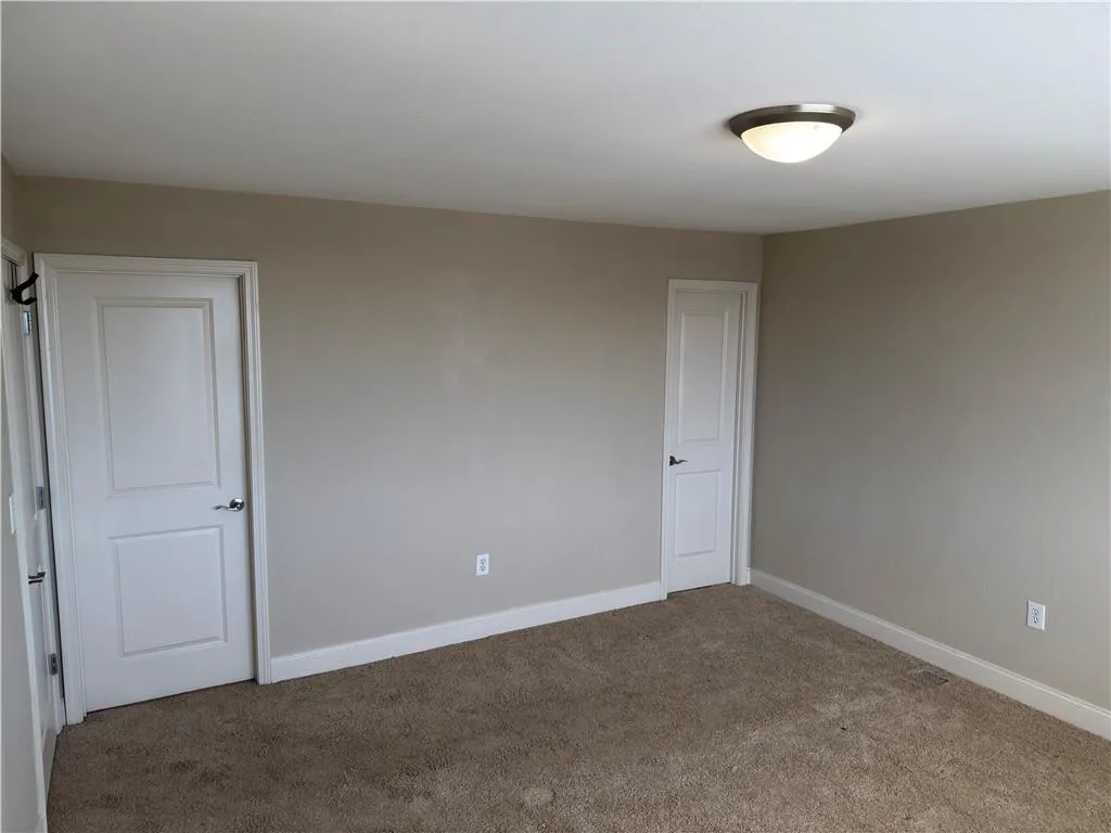 Unfurnished room with baseboards and carpet floors