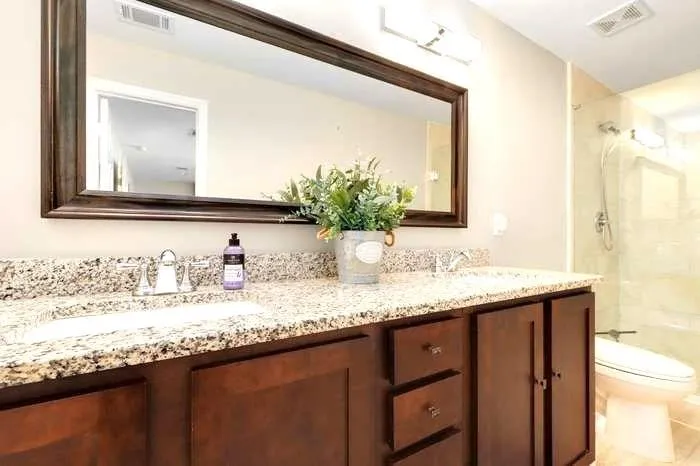 Bathroom featuring dual vanity and toilet