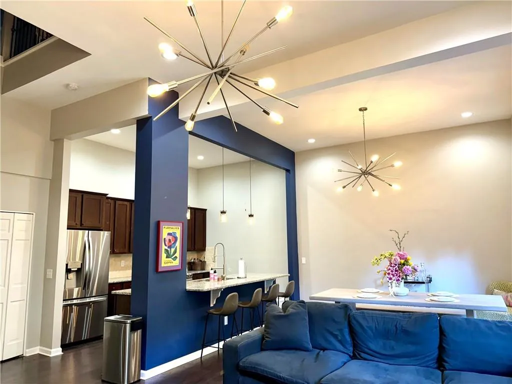 Living room featuring sink, a chandelier, and dark hardwood / wood-style flooring