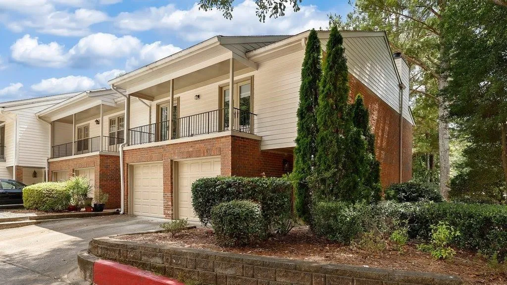 Townhome / multi-family property with a balcony and a garage