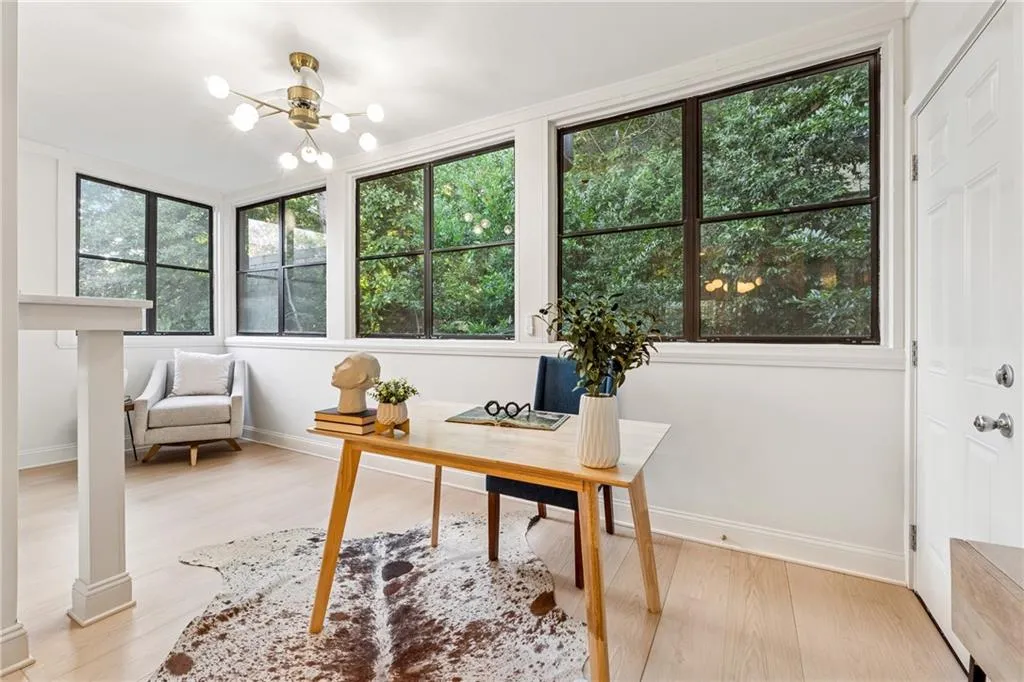 Office area featuring light wood-style floors and a chandelier