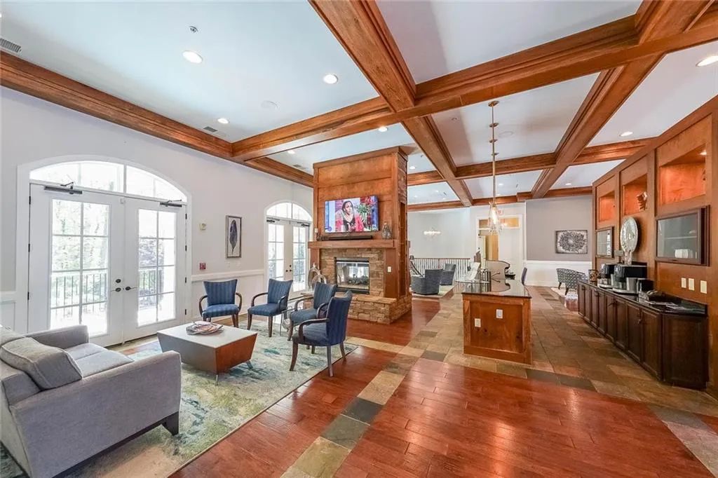 Living area with dark wood finished floors, coffered ceiling, visible vents, french doors, and beamed ceiling