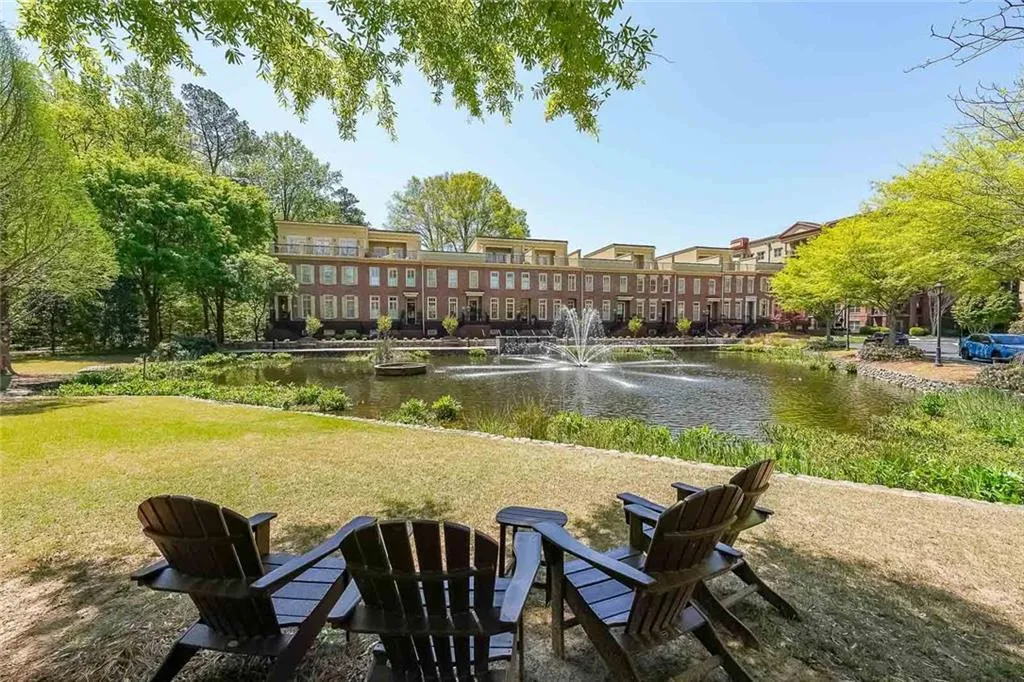 View of property's community with a lawn and a water view