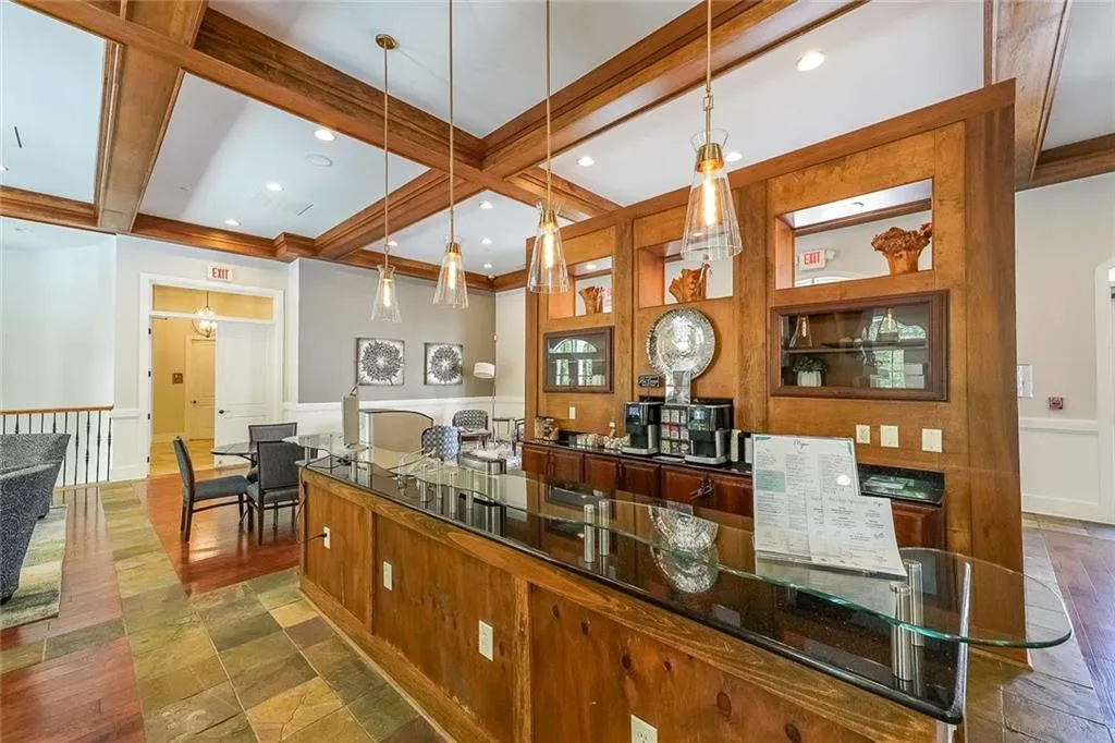 Kitchen with coffered ceiling, hanging light fixtures, beam ceiling, and recessed lighting