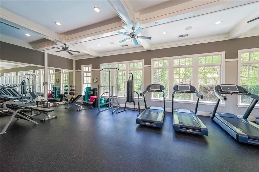 Exercise room featuring visible vents, recessed lighting, coffered ceiling, and ceiling fan