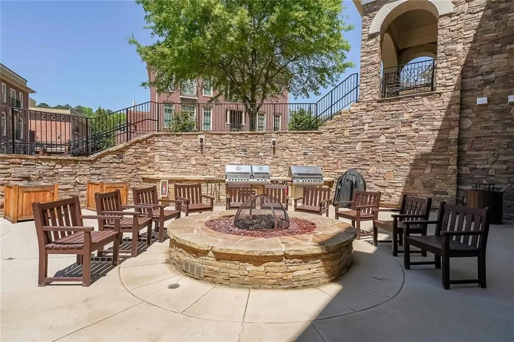 View of patio / terrace with a fire pit and grilling area
