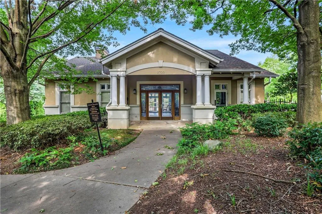 Doorway to property featuring french doors, stucco siding, and roof with shingles