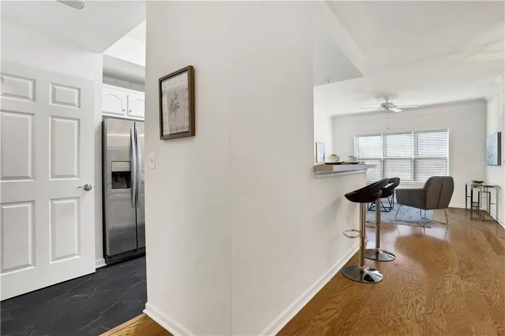 Corridor featuring baseboards and dark wood-style floors