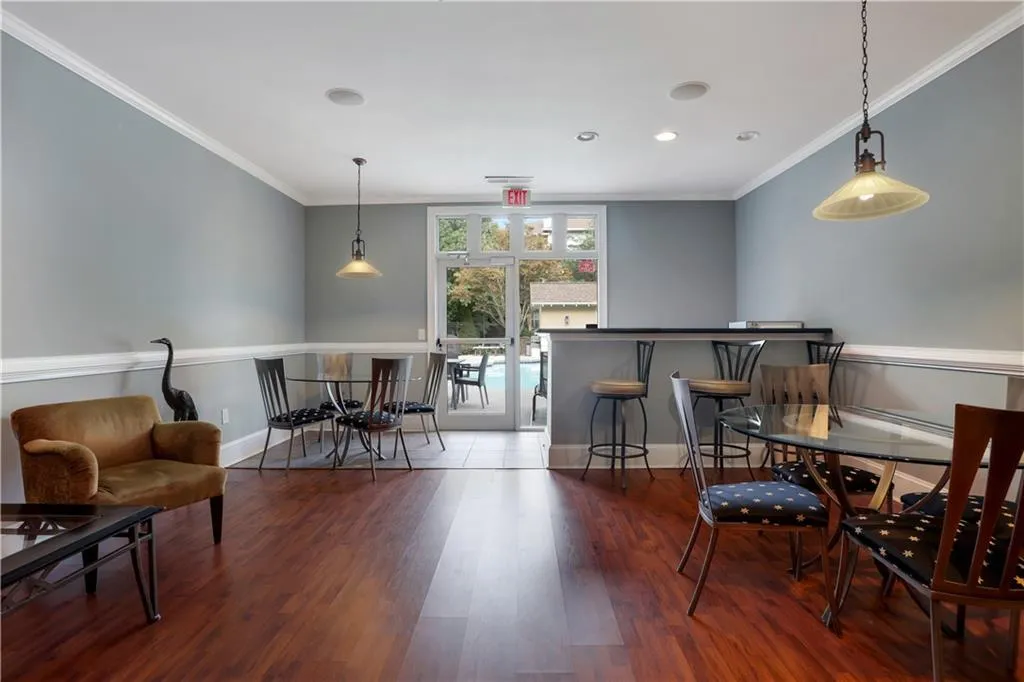 Dining room with dark wood finished floors and crown molding